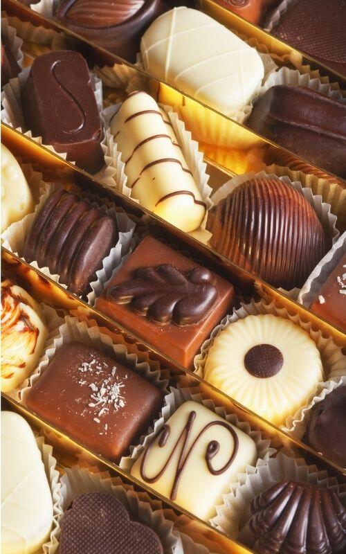 A delightful assortment of Belgium chocolates artfully arranged in a charming box.