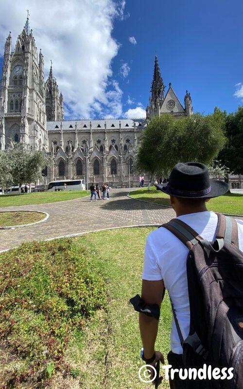 man looking at church in quito