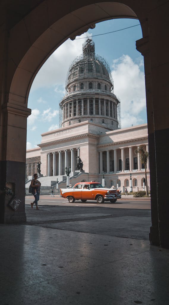 Woman Walking on Sidewalk In The City Of Havana