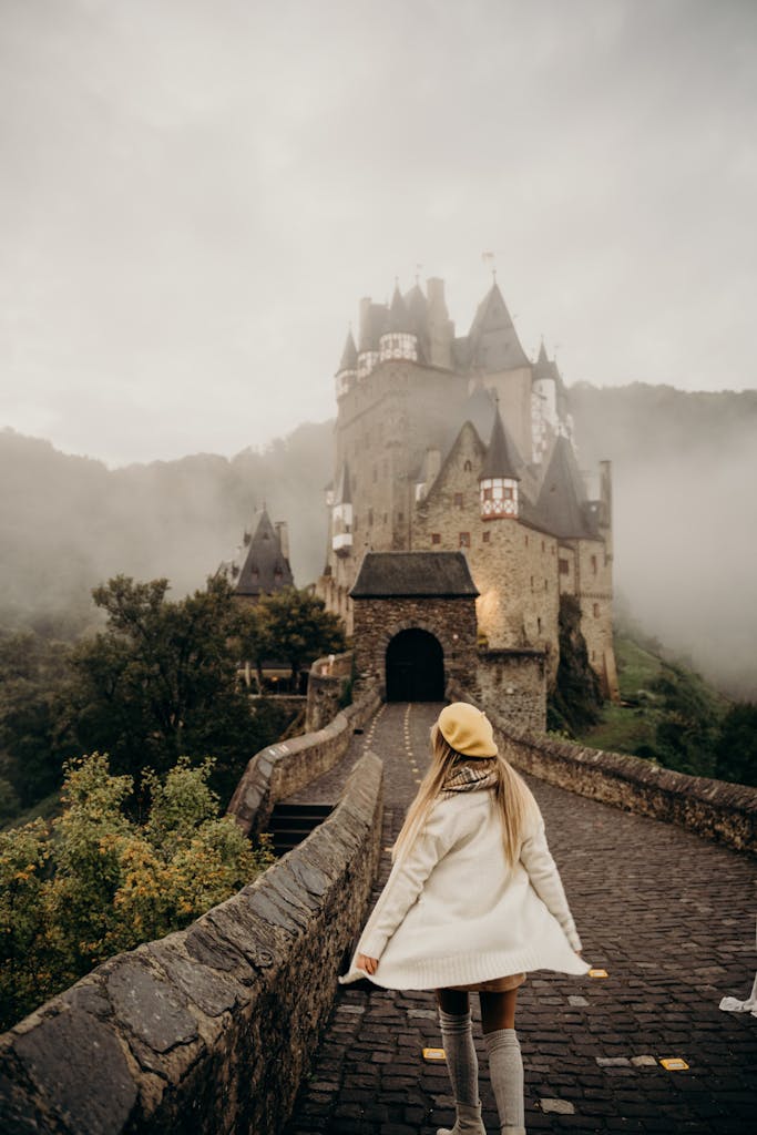 Woman Walking Towards a Castle