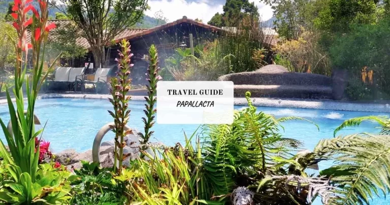 Scenic view of a garden pool with plants and a distant building, labeled "Travel Guide Papallacta.