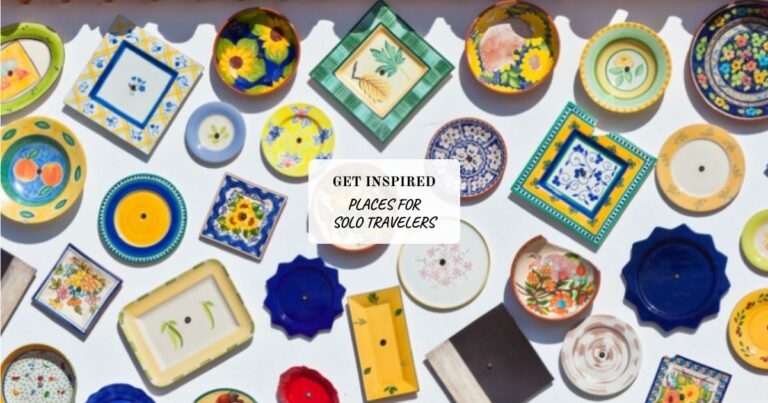 Colorful ceramic plates and dishes on a white wall, with a sign: "Get inspired: Places for solo travelers".